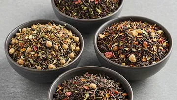 Four bowls of mixed dry tea ingredients.