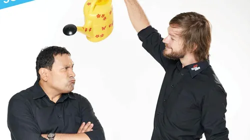 Two men with a yellow watering can.