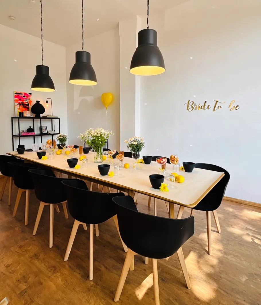 Decorated dining table with chairs in bright room.