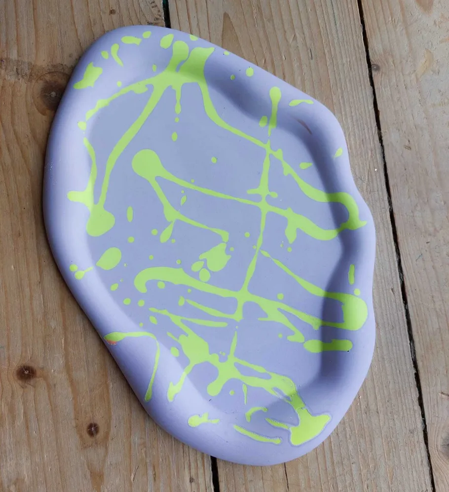 Abstract purple tray with lime green splatter design.