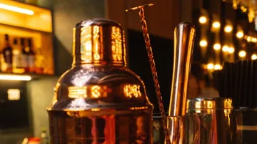 Copper cocktail shaker on a bar counter.