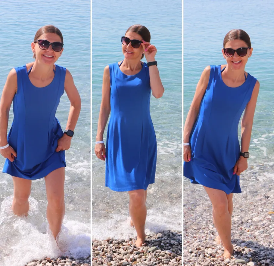Woman in blue dress by the sea.