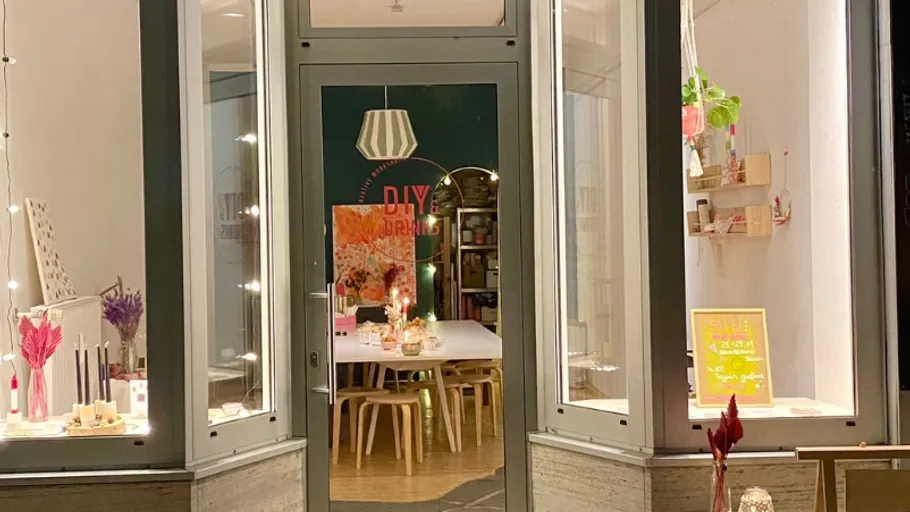Storefront with festive decorations and table inside.