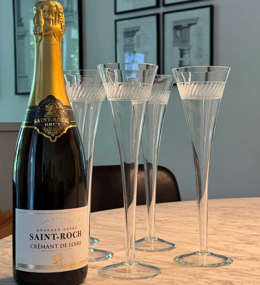 Wine bottle and glasses on table indoors.