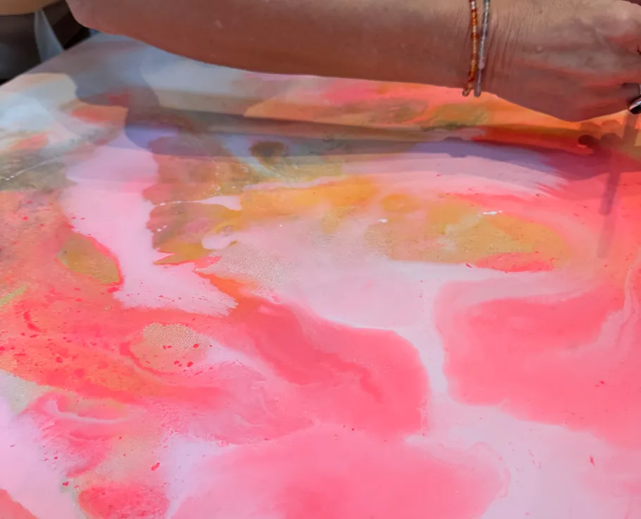 Hand painting vibrant abstract with brush.