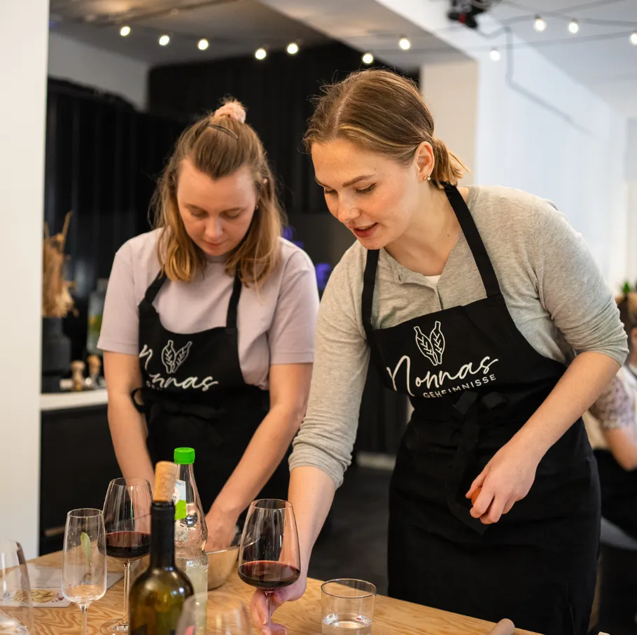 Two women cooking in a kitchen.