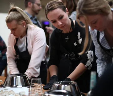 People making food in a cooking class.