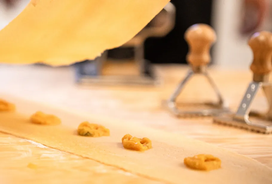 Ravioli preparation on wooden table.
