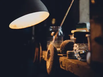 Workbench with a glowing lamp and various tools.