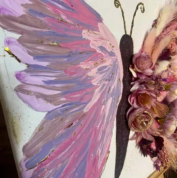 Colorful butterfly art with flower decorations.