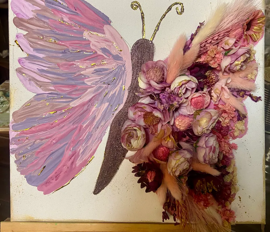 Butterfly art with painted and floral wings.