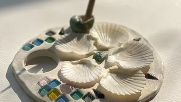 Decorative dish with shells and glass tiles.