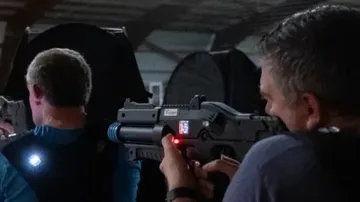 Men playing laser tag inside an arena.