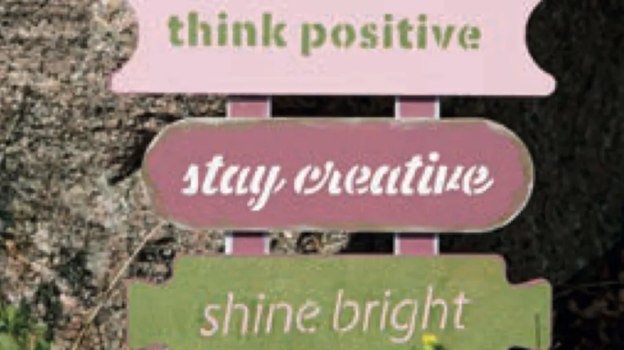 Colorful signs with motivational phrases outdoors.