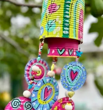 Colorful tin can wind chime outdoors.
