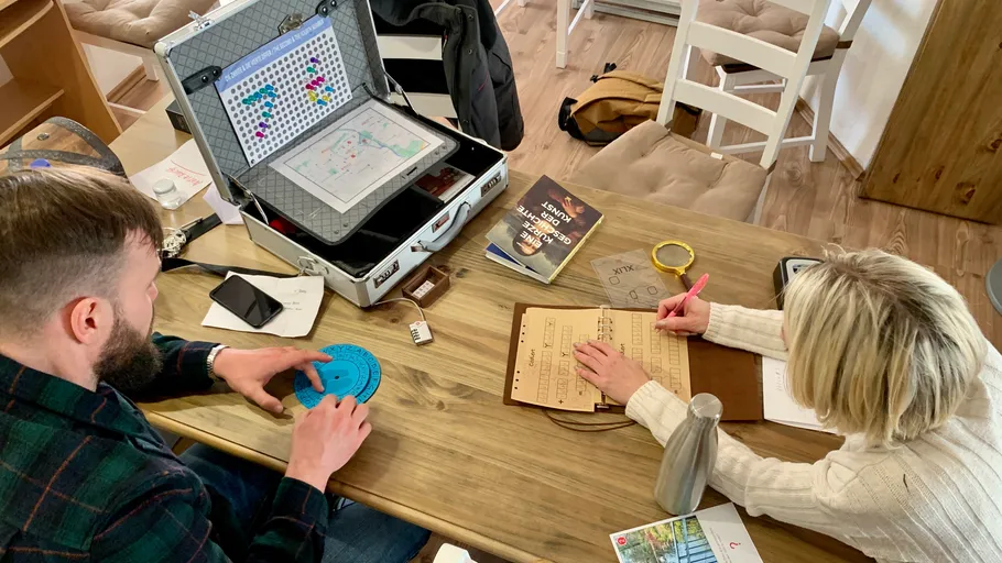 Two people solving puzzles at a table.