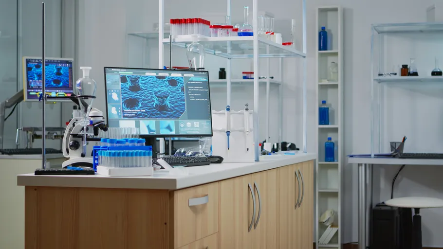 Laboratory with computer, microscope, and test tubes.