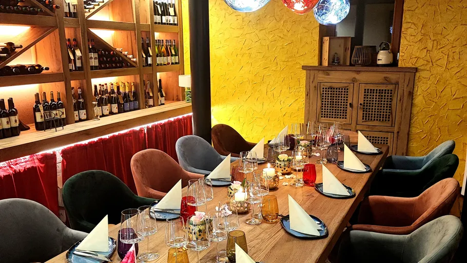 Dining table set with glasses and napkins.