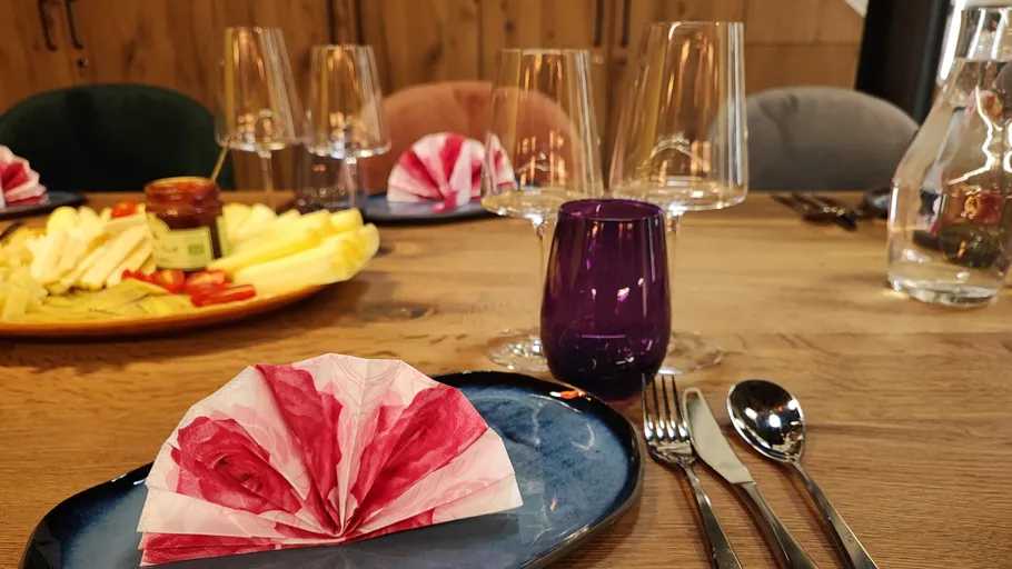 Table setting with folded napkins and glasses.