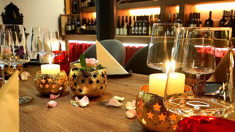 Table with candles and wine glasses in restaurant.