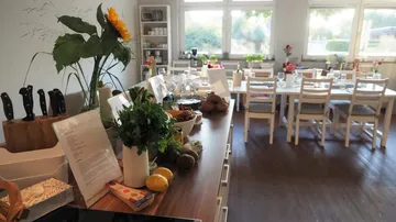 Kitchen with table settings and ingredients displayed.