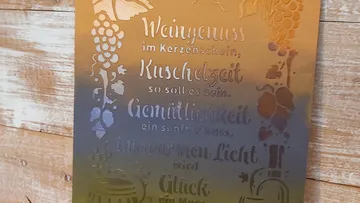 Metal plaque with decorative German text.