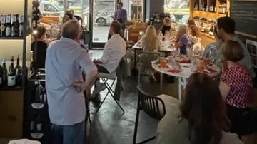 People sitting and listening in a restaurant.