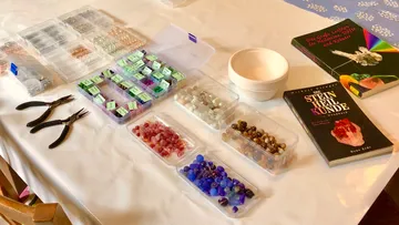 Beads and tools on a crafting table.
