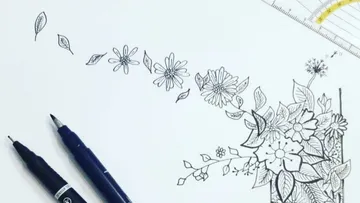 Pen sketch of flowers and leaves on paper.