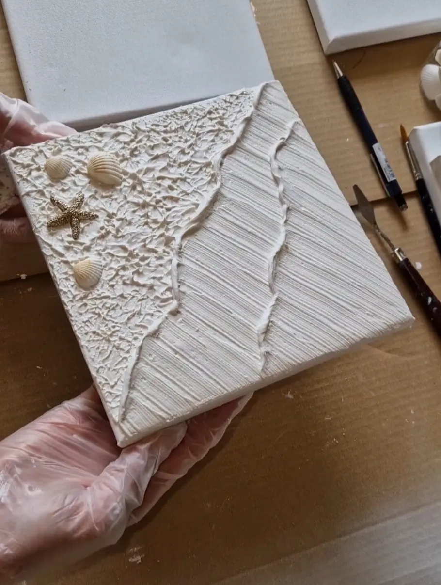 Textured canvas with shells and starfish added.