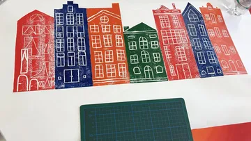 Colorful printed buildings on a table.