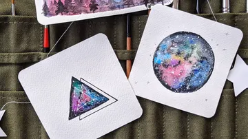 Colorful watercolor paintings of galaxy patterns.