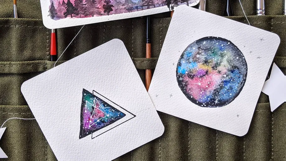 Colorful watercolor paintings of galaxy patterns.