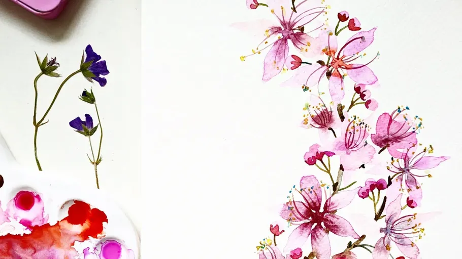 Watercolor flowers and paints on a white paper.