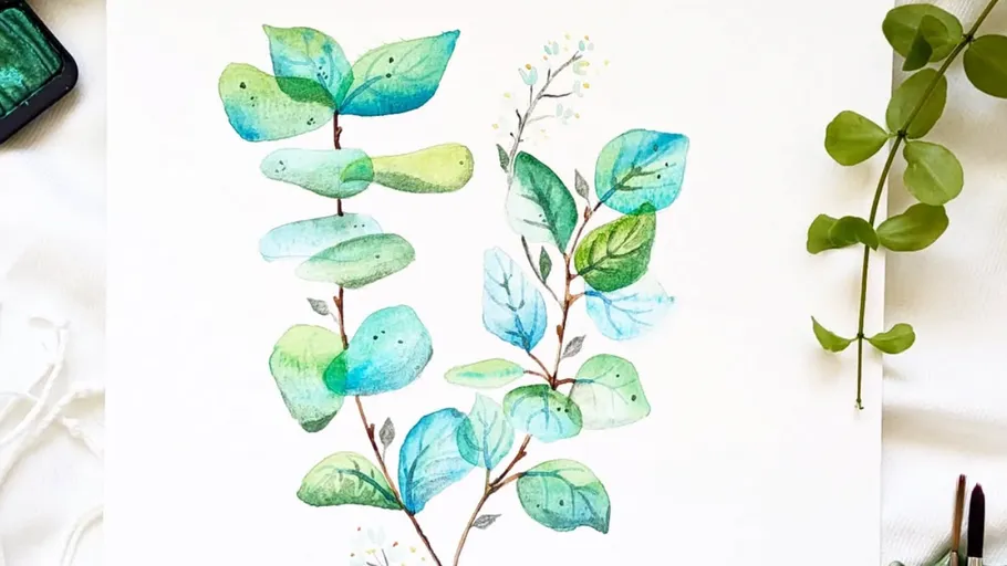 Watercolor painting of green leaves on paper.