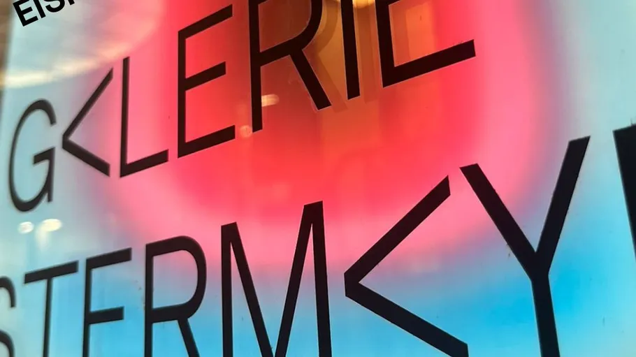 Text on a colorful neon-lit sign.