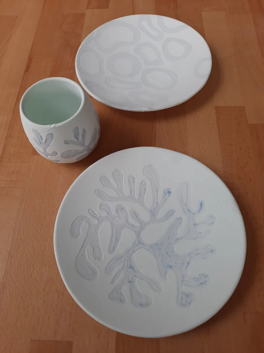 Handcrafted pottery on wooden table.