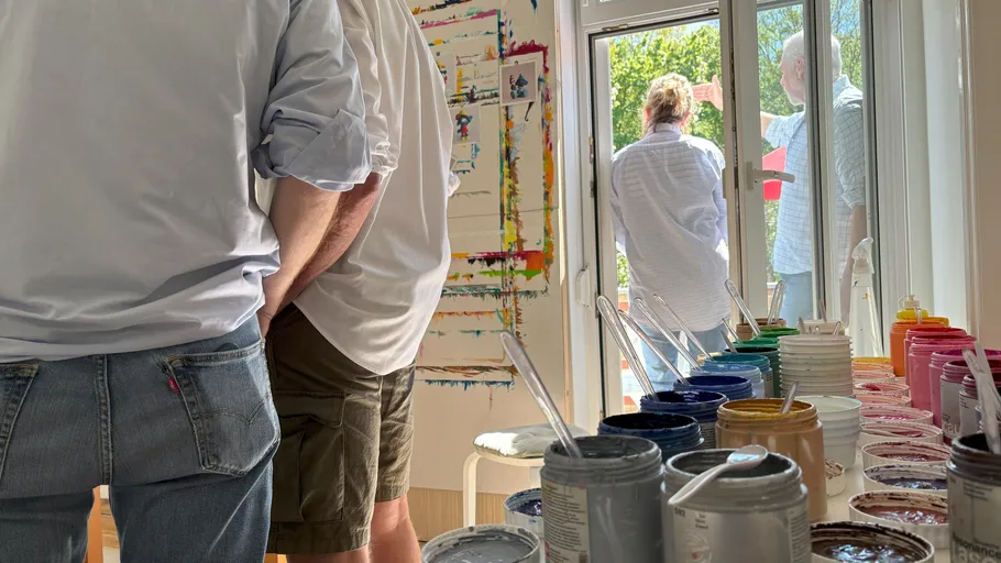 People in art studio with paint jars.