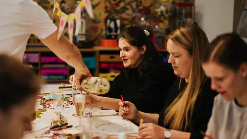 People drawing at a creative workshop table.