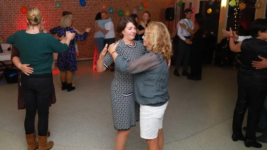 Couples dancing in a decorated room.