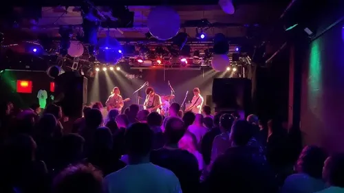 Band performs on stage in front of crowd.