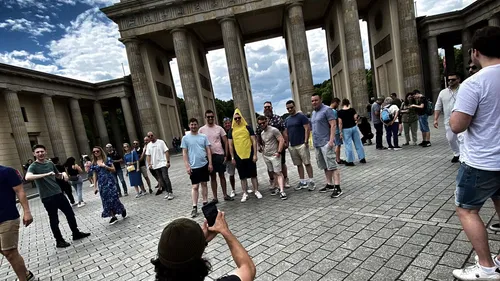 Group posing at Brandenburg Gate, Berlin.