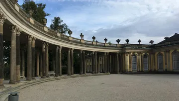 Baroque palace with columns in courtyard.