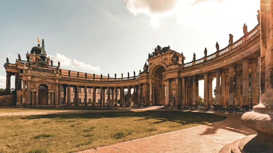 Grand colonnade in ornate architectural courtyard.
