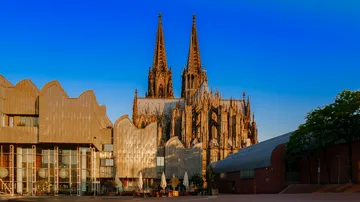 Gothic cathedral with modern buildings around.
