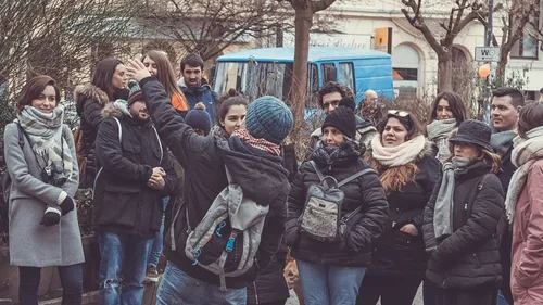 Group listening to guide in city street.
