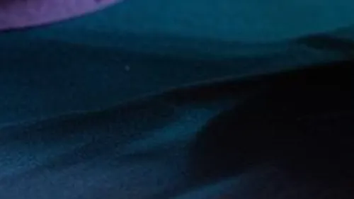 Colorful bowl on table with decorative items.