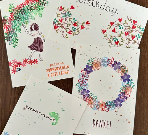 Colorful greeting cards on wooden surface.