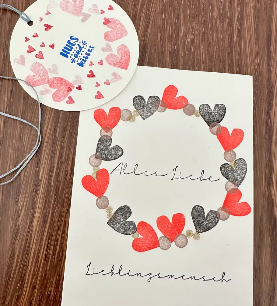 Heart-decorated card with love message on wood.