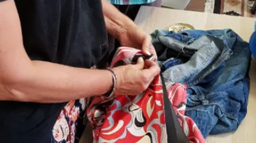 Person holding colorful fabric in hands.